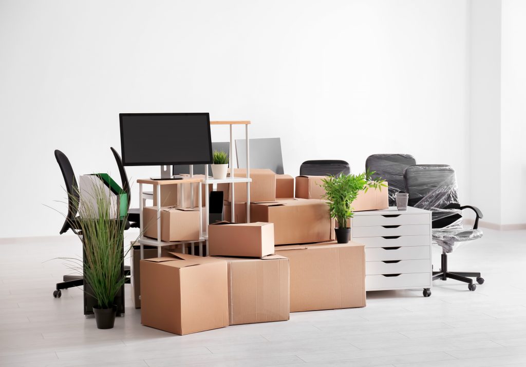Carton boxes with stuff in empty room. Office move concept Carton boxes with stuff in empty room. Office move concept