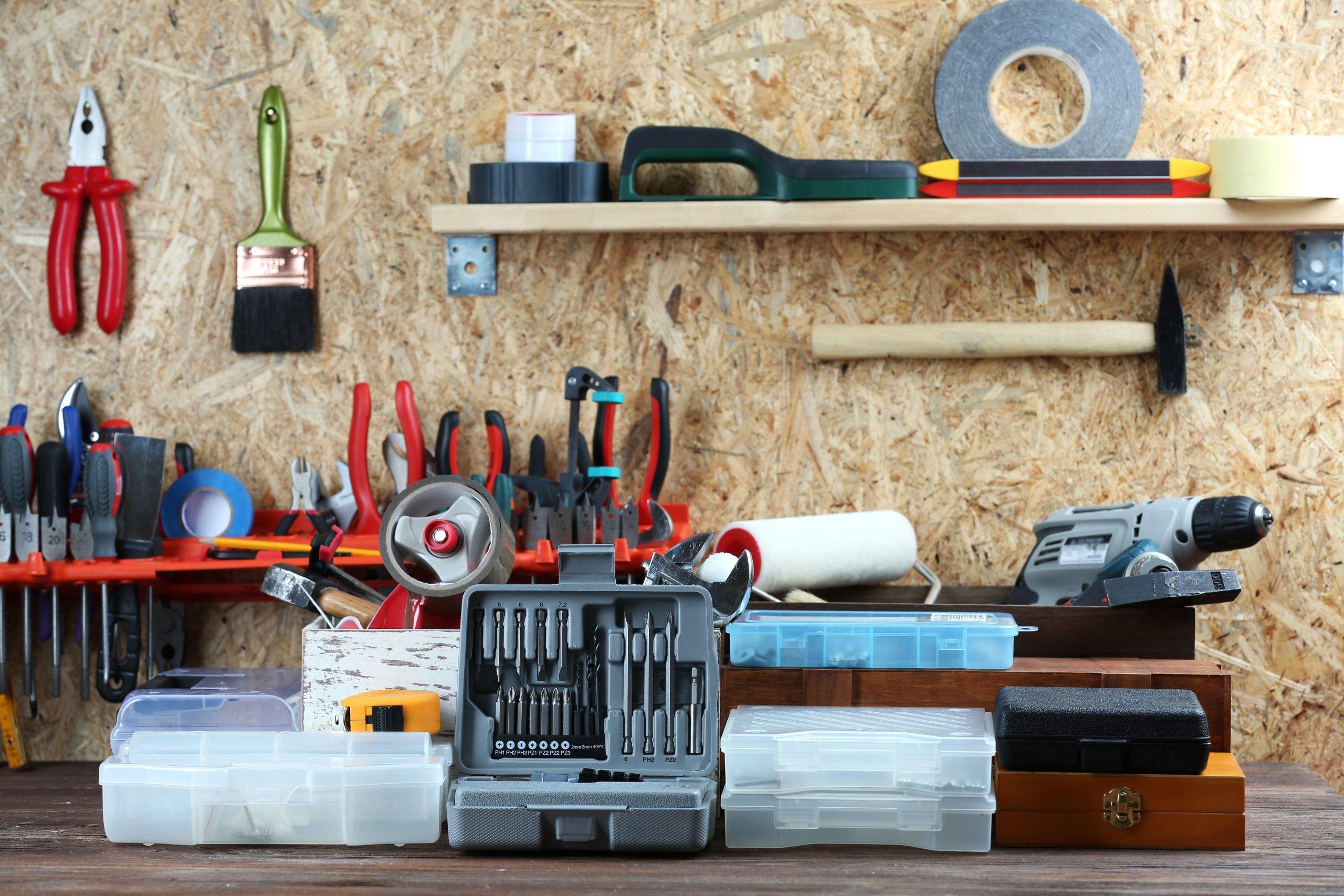 Set of tools in workshop on plywood background Set of tools in workshop on plywood background